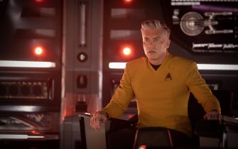 Captain Christopher Pike sitting in the captain's chair on the bridge of the U.S.S. Enterprise.