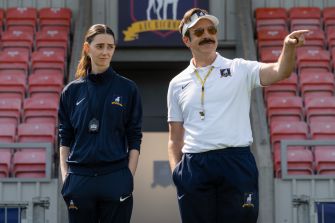 A scene from "Ted Lasso," featuring Jason Sudeikis as Ted and another character in a coaching setting.