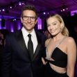 Bradley Cooper and Margot Robbie posing together at an event. Bradley Cooper and Margot Robbie posing together at an event.