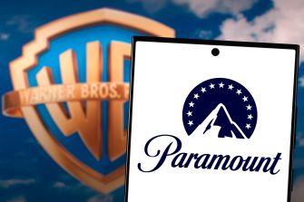 Logos of Paramount and Warner Bros. against a blue sky background.