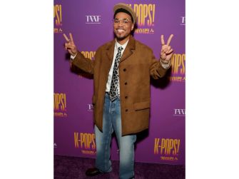 Anderson .Paak posing with peace signs at the premiere event for his film K-Pops!