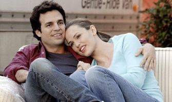 A scene from the original film "13 Going on 30," featuring two characters sitting close together on a couch.