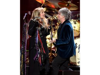 Stevie Nicks and Lindsey Buckingham performing together on stage.