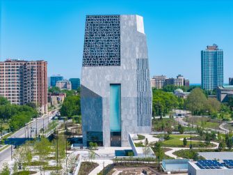 The Obama Presidential Center in Chicago, featuring a modern architectural design set against a clear blue sky.