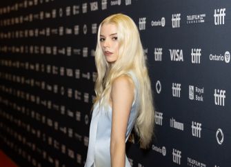 Anya Taylor-Joy posing on the red carpet at a film festival event.