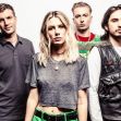 Wolf Alice band members posing for a promotional photo. Wolf Alice band members posing for a promotional photo.