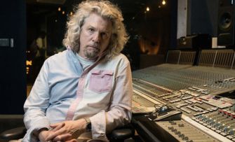 Bob Power, an influential hip-hop and R&B engineer, seated at a recording studio mixing console.