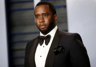 Sean "Diddy" Combs attending a formal event, wearing a black tuxedo and bow tie.