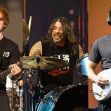 Collage of Ed Sheeran, Dave Grohl, and John Mayer performing on stage. Collage of Ed Sheeran, Dave Grohl, and John Mayer performing on stage.