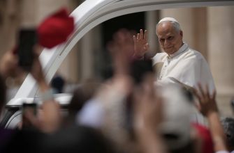 Pope Leo XIV waving to a crowd during a public appearance.
