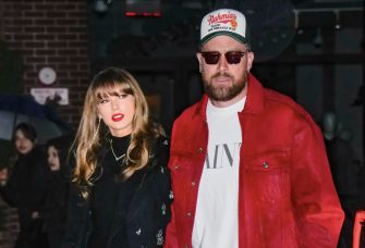 Taylor Swift and Travis Kelce walking together in a public setting.