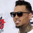 Chris Brown at a red carpet event, wearing sunglasses and a white shirt. Chris Brown at a red carpet event, wearing sunglasses and a white shirt.