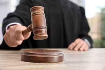 A judge striking a gavel during a court proceeding.
