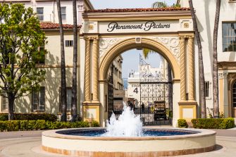Entrance to Paramount Pictures studio lot in Los Angeles, featuring the iconic archway and fountain.