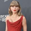 Taylor Swift at a red carpet event, wearing a stunning red dress with elegant accessories. Taylor Swift at a red carpet event, wearing a stunning red dress with elegant accessories.