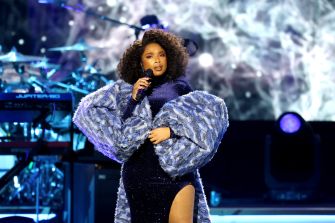 Jennifer Hudson performing on stage in a stylish blue outfit during a musical event.