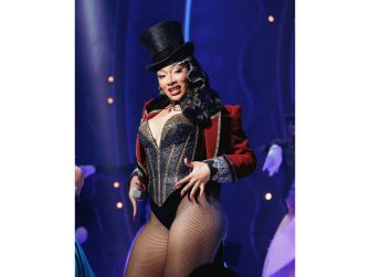 Megan Thee Stallion performing in Moulin Rouge! The Musical, wearing a hat and a sparkling costume.
