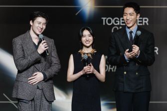 A group of younger actors at the Asian Film Awards, including Natalie Hsu, Mean Phiravich, and Kent Tsai, standing together and smiling while holding microphones.