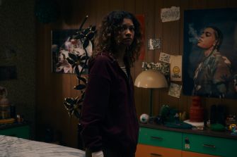 A somber scene featuring a character in a dimly lit bedroom, reflecting emotional turmoil, with posters and personal items in the background.