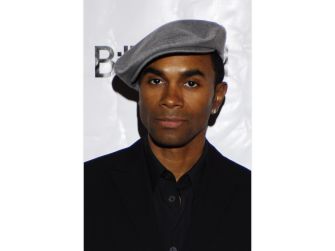 Fab Morvan wearing a gray hat at an event, looking directly at the camera.