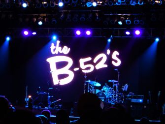The stage setup for the B-52s, lit with purple lights, before their canceled performance at a music festival.