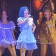 Halsey performing on stage surrounded by dancers, dressed in colorful outfits during her "For My Last Trick" tour concert. Halsey performing on stage surrounded by dancers, dressed in colorful outfits during her "For My Last Trick" tour concert.