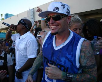 Vanilla Ice performing at an event, surrounded by fans.