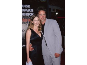 Denise Richards and Patrick Muldoon together at a movie premiere, smiling while embracing each other.