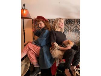 Courtney Love and Melissa Auf der Maur posing together, with a dog, hinting at a potential reunion.