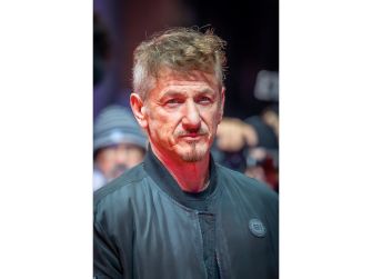 Sean Penn during an event, appearing serious and contemplative.