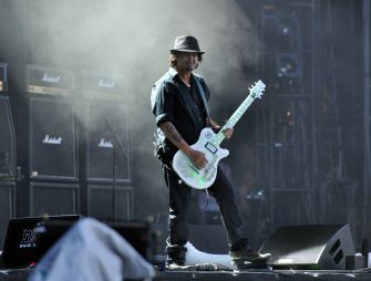 Phil Campbell performing on stage with his guitar.