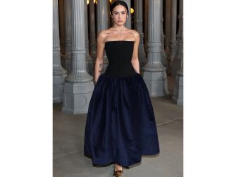 Demi Lovato wearing a strapless black and navy gown at a public event.