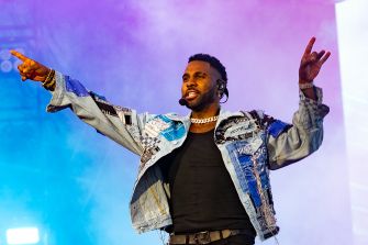 Jason Derulo performing on stage during a live concert event.