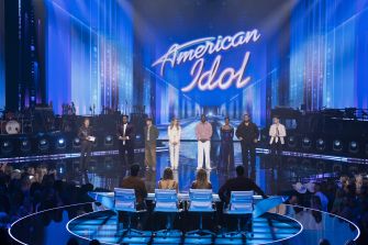 A stage view from the latest season of 'American Idol,' featuring contestants and judges.