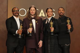 Two men in formal attire posing together on the red carpet at an awards ceremony.