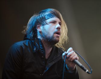 Caleb Shomo, frontman of Beartooth, performing live on stage.