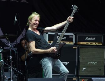 Francis Buchholz performing on stage as the bassist for the Scorpions.
